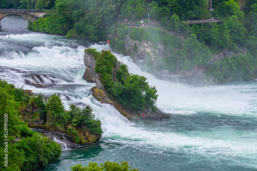 Central rock of Rhine falls with stairs and Swiss flag on the top  Schaffhausen  Switzerland