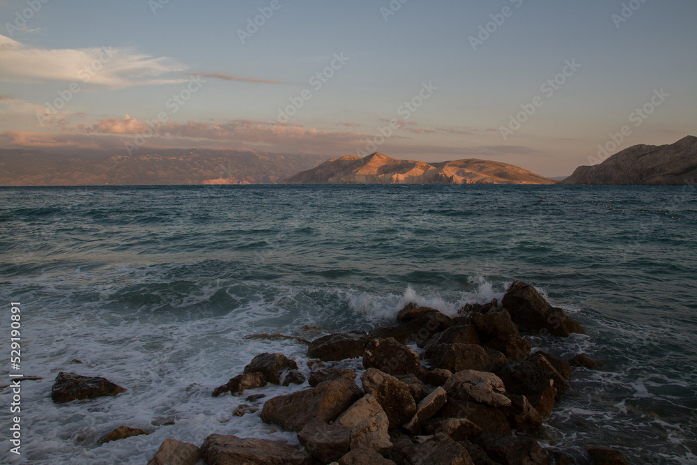Romantic seascape of the rocky coast of the Mediterranean Sea near Baska, island of Krk, Croatia, at sunset