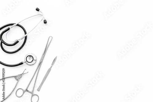 Dental or surgical steel instruments with stethoscope. Healthcare background photo