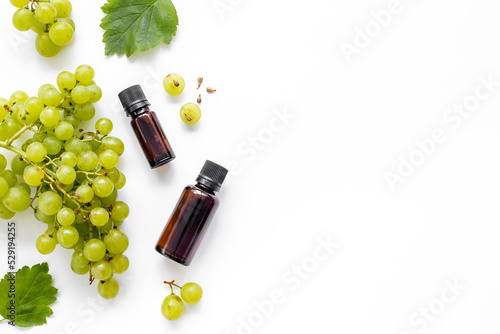 Grape seed oil in bottles with bunch of grapes. Eco cosmetic product