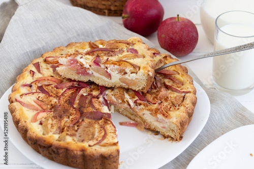 American classic sour cream pie with apples on a white wooden background