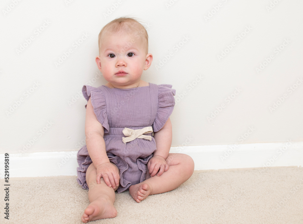 Cute caucasian baby girl learning how to sit at 9 month old Cute caucasian baby girl learning how to sit at 9 month old
