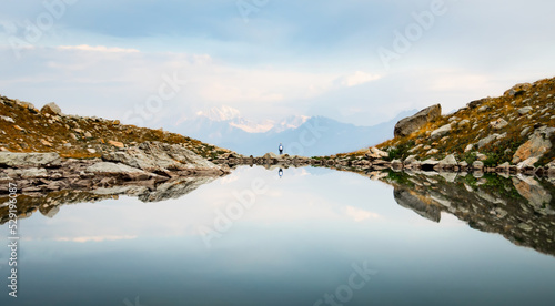 Back view person female stand on edge in nature calm landscape look to sides search purpose in life alone in scenic mountains in fall