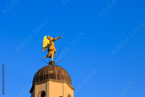 statue of the angel on the bell tower of the Church of Santa Maria di Castello in Udine photo
