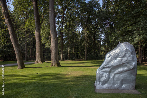 trees in park and sculpture at kroller moller museum, art museum, national park hoge veluwe, gelderland, netherlands,  photo