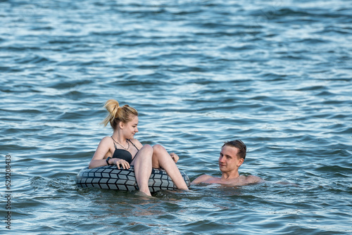 Young guy and girl swim in the lake © kulkann