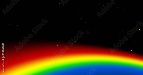 Image of rainbow and colourful light trail moving on black background