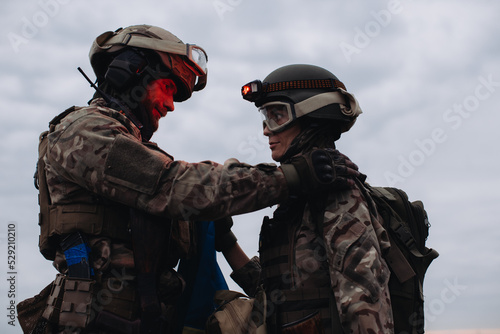 Brothers in arms, man and woman. Ukrainian military against the background of the sky. War between Ukraine and Russia.