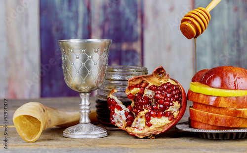 There are four traditional symbols of Rosh Hashanah for Jewish New Years holiday apples, honey, pomegranates, and shofars.