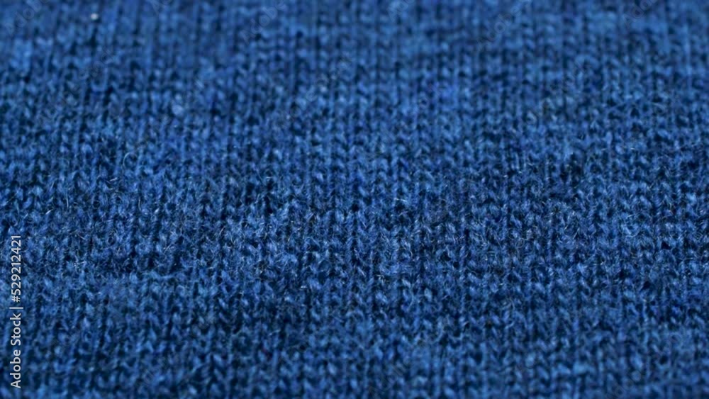 Blue knitted fabric texture. Closeup detailed sweater fabric background. Soft woolen textile pattern for winter fashion background Blue knitted fabric texture. Closeup detailed sweater fabric background. Soft woolen textile pattern for winter fashion background