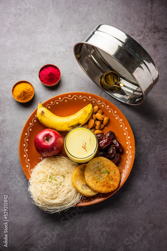 Sargi - pre-dawn meal for karwa chauth or karva chauth puja served with Chalni or strainer and diya photo