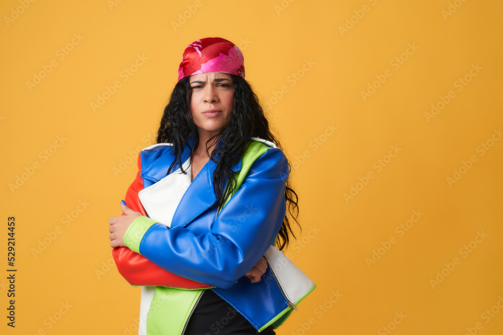 young woman with pink headscarf and colorful leather jacket with angry gesture young woman with pink headscarf and colorful leather jacket with angry gesture