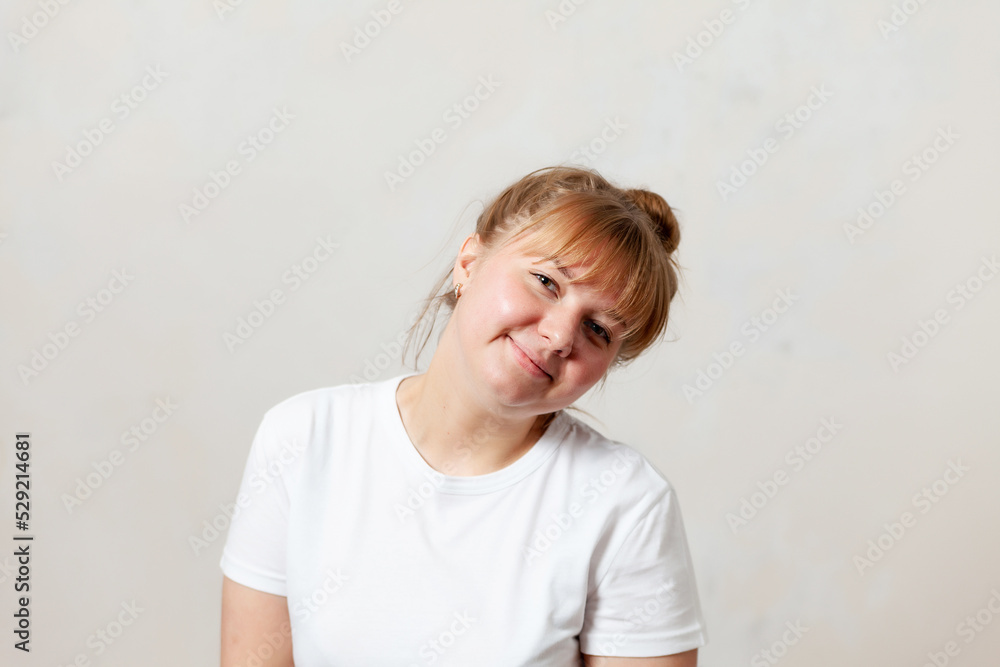 Portrait of 25-year-old American girl against white wall Portrait of 25-year-old American girl against white wall