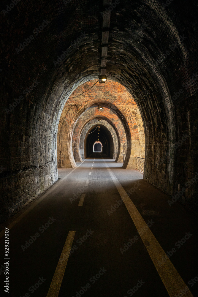 Cycle path in Liguria built on the old train route. Tunnel made from red bricks