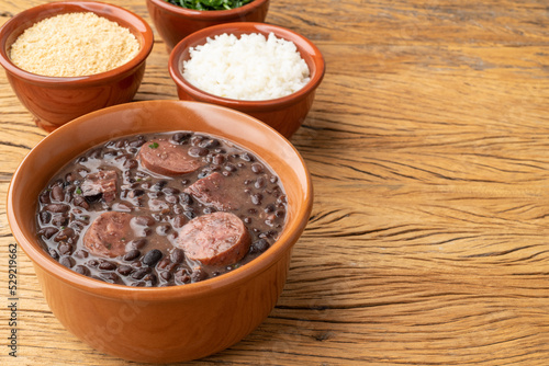 Typical brazilian feijoada with farofa, rice, kale and copy space
