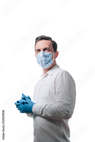 Obraz na płótnie male doctor in a medical mask on his face and gloves on a white background w salonie