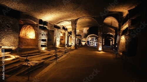 Tunnels of catacombs underground with burial holes