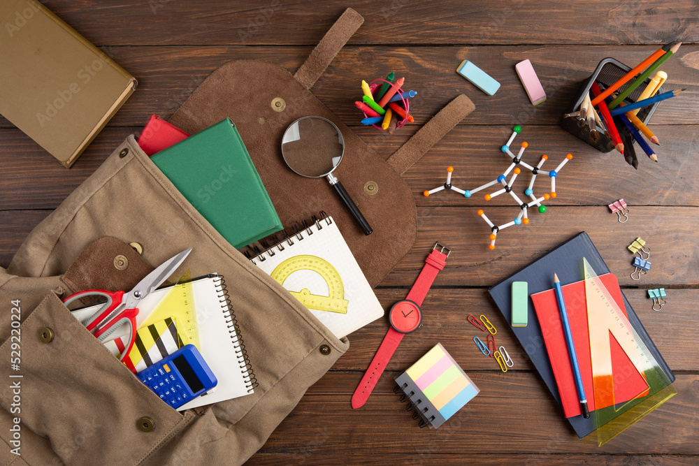 Obraz premium Back to school - books and school backpack on the desk in the auditorium, Education concept.