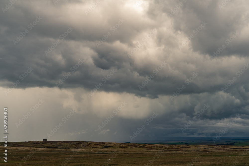 Dramatic storm clouds over Northumberland countryside