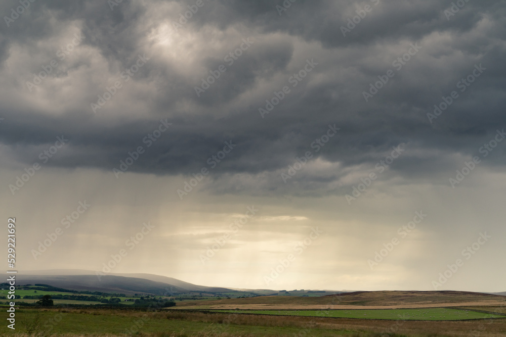 Dramatic storm clouds over Northumberland countryside