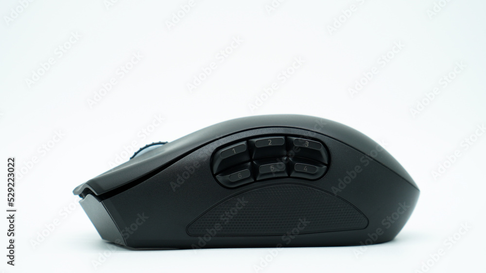 Modern black gaming mouse with six side buttons on white background. Modern black gaming mouse with six side buttons on white background.
