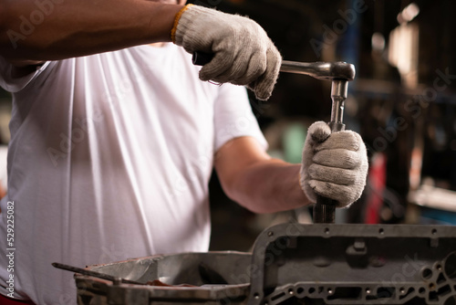 Wallpaper Mural Auto mechanic working and repair on car engine in mechanics garage. Car service. male mechanic repairs car in garage. Car maintenance and auto service garage concept. Torontodigital.ca