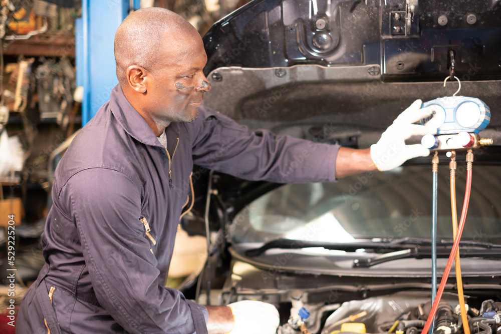Portrait of a confident African American male Mechanic in the garage. Portrait of a confident African American male Mechanic in the garage.