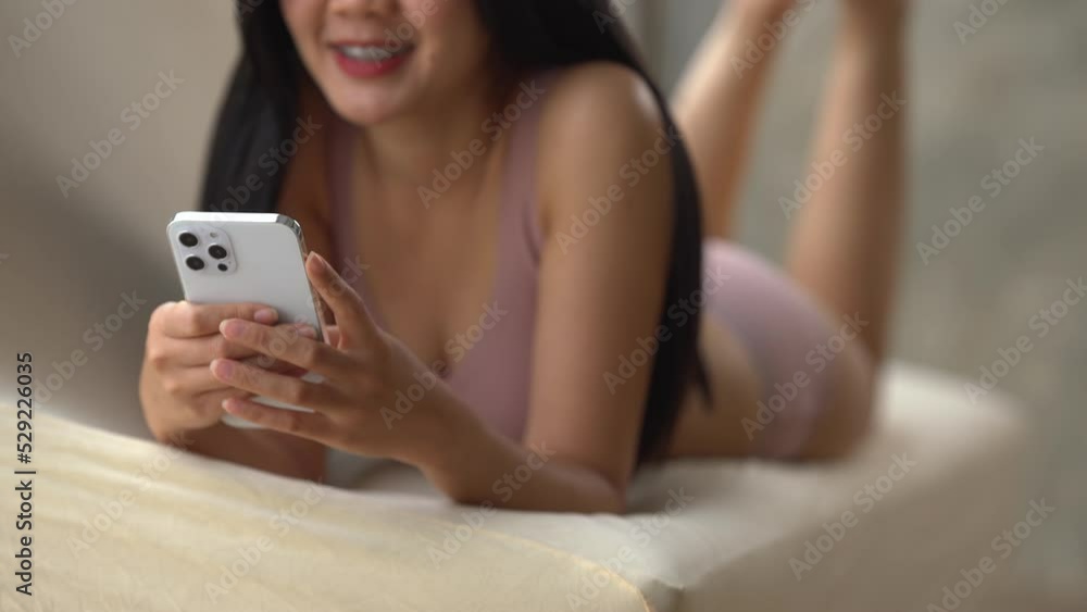 Sexy woman wearing bra and panties using mobile phone on sofa. Sexy woman wearing bra and panties using mobile phone on sofa.