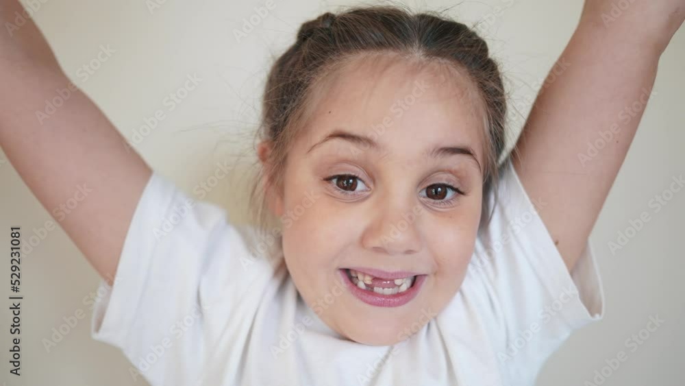 portrait child indoors girl looking at the camera. happy family kid dream concept. baby eyes down then look at the camera and smiles. funny portrait girl kid close-up. smile teeth fell out portrait child indoors girl looking at the camera. happy family kid dream concept. baby eyes down then look at the camera and smiles. funny portrait girl kid close-up. smile teeth fell out