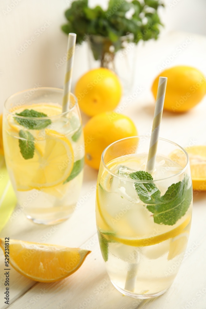 Fototapeta premium Cool freshly made lemonade and fruits on white wooden table