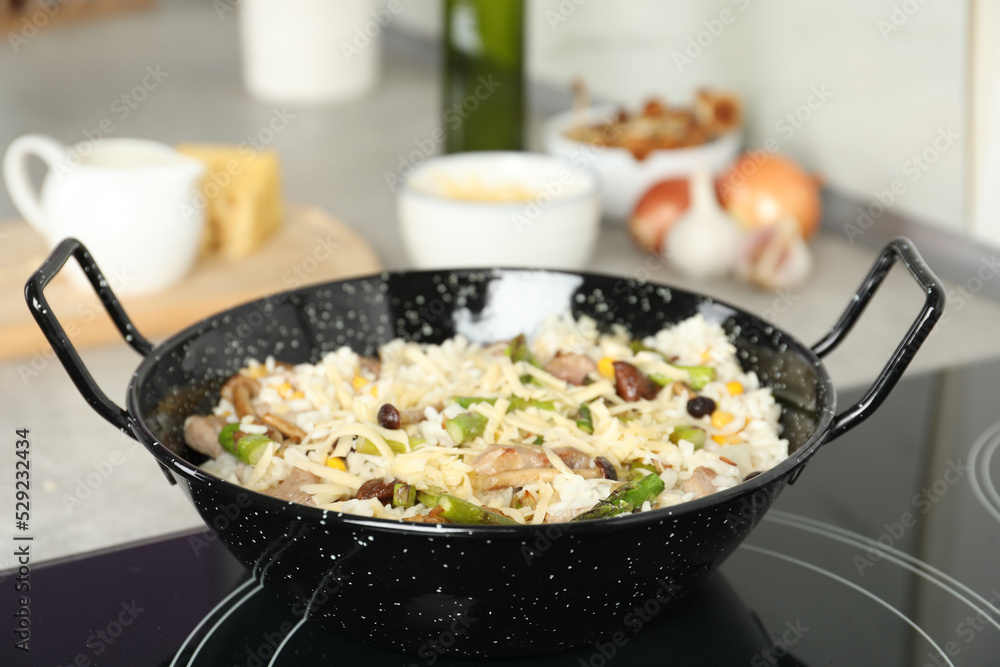 Delicious risotto in pan on induction stove Delicious risotto in pan on induction stove