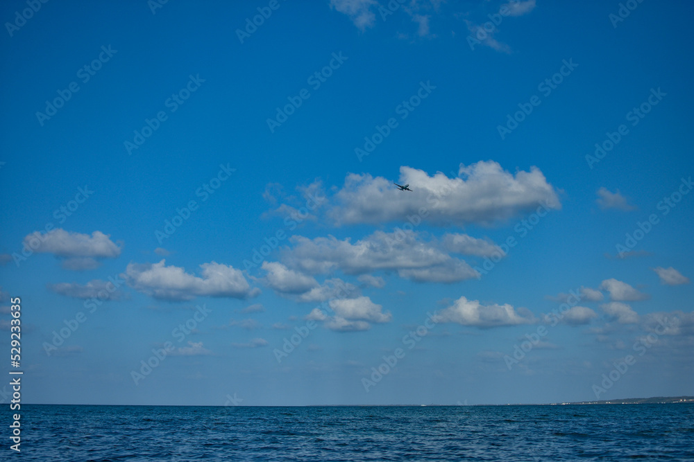 宮古島マリンブルーの海と青空と飛行機