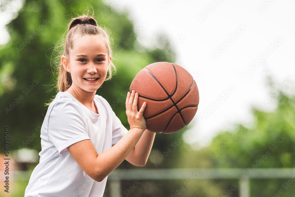 portrait of a kid girl playing with a basketball in park portrait of a kid girl playing with a basketball in park