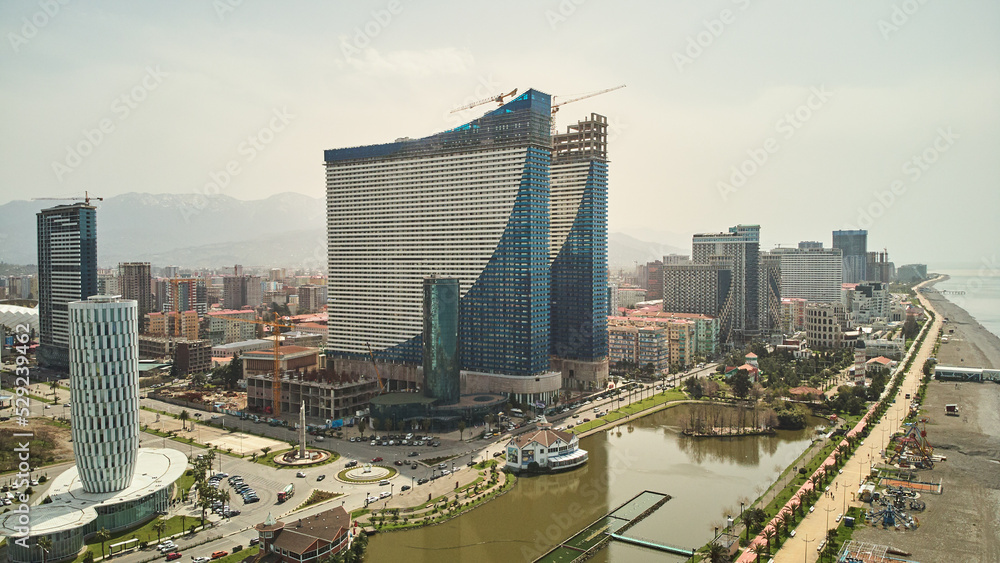 Obraz premium Aerial view of the modern architecture of Batumi with mountains background. High quality photo