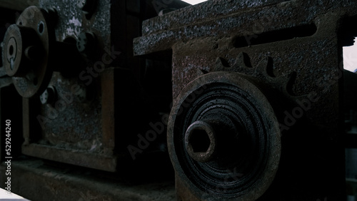 Rusty gears and pulley from old mechanism photographed at close range 