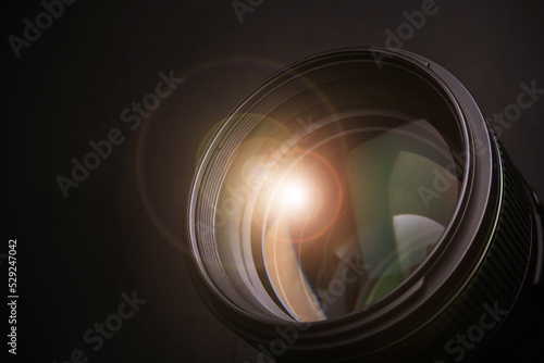 Modern camera lens on black background, closeup