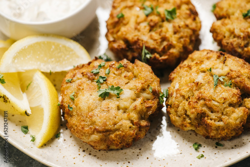 Homemade crab cakes on a plate with lemon photo