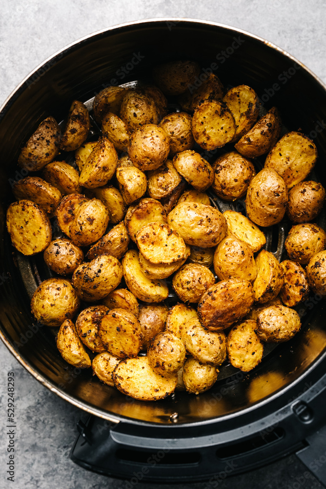 Overhead spicy Yukon Gold potatoes in an air frier Overhead spicy Yukon Gold potatoes in an air frier