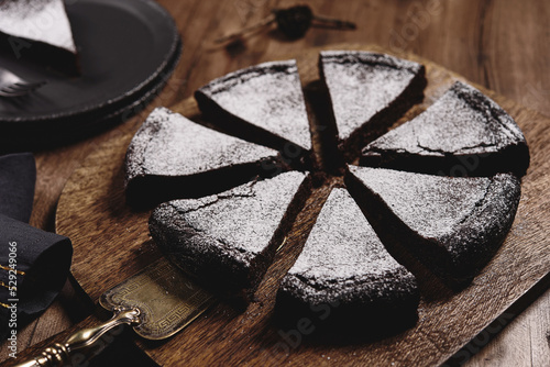Kladdkaka. Traditional Swedish moist chocolate cake on wooden table. Fika. Hygge. Winter treat