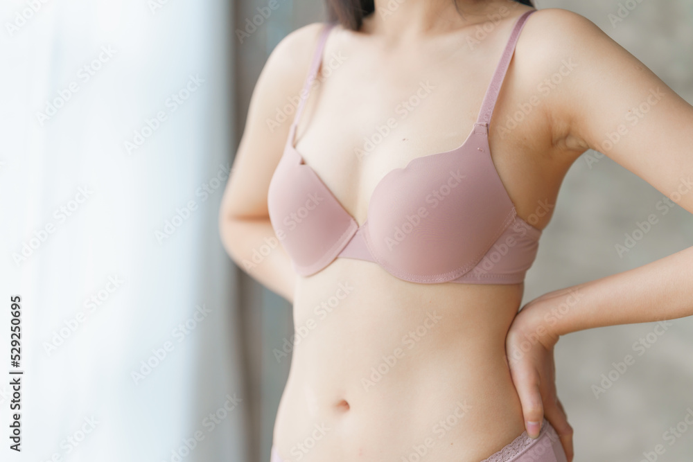 Closeup of sexy asian female boob in pink bra. Closeup of sexy asian female boob in pink bra.