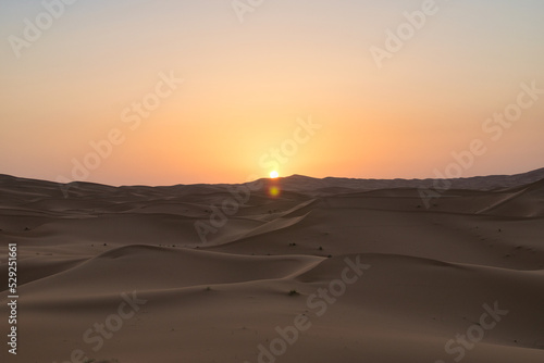 Dunes in the Sahara desert at sunrise, the desert near the town of Merzouga, a beautiful African landscape