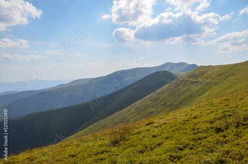 Bright colors of emerald mountain slopes in the light of the sun on a summer day. The concept of outdoor activities and mountain hiking. Borzhava range, Carpathians, Ukraine