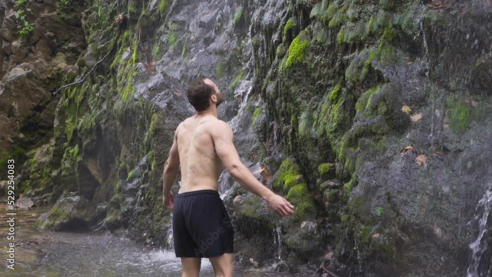 Sporty man stands in front of waterfall. Slow motion.
Young man washing his face with water from the stream in the forest.
Sporty man stands in front of waterfall. Slow motion.
Young man washing his face with water from the stream in the forest.