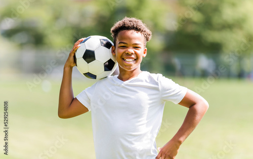 happy multicultural hispanic soccer player outdoor in sunny day