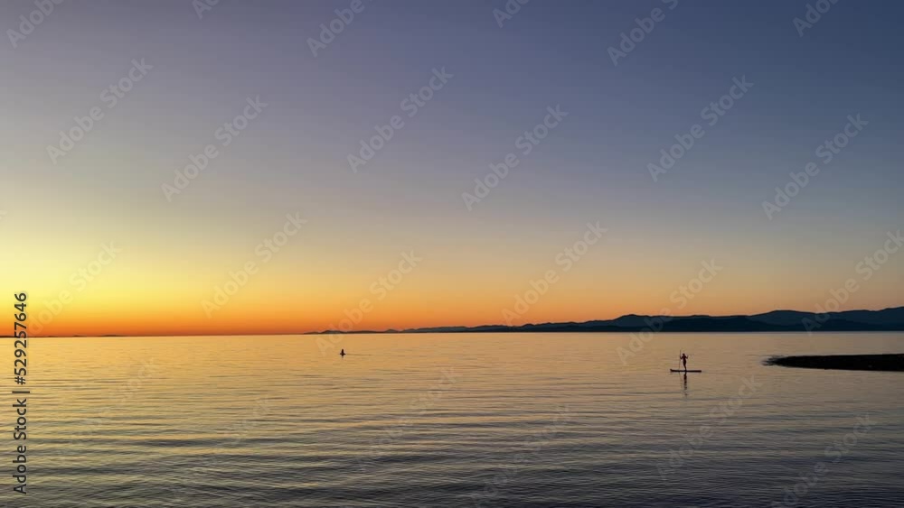 sunset on Ocean Calmness and silence is like a lake or sea on resting in trailers on the shore bright colors of dark blue orange stripe on the horizon from sun rich space for text travel advertising sunset on Ocean Calmness and silence is like a lake or sea on resting in trailers on the shore bright colors of dark blue orange stripe on the horizon from sun rich space for text travel advertising