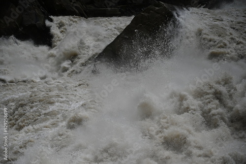 The mighty river crushing against the famous Tiger Leaping Gorge in Yunnan province of Western China - the water flow in the river forming the gorge is incredible in terms of volume and speed