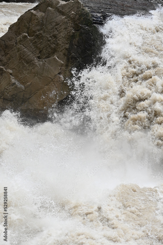 The mighty river crushing against the famous Tiger Leaping Gorge in Yunnan province of Western China - the water flow in the river forming the gorge is incredible in terms of volume and speed The mighty river crushing against the famous Tiger Leaping Gorge in Yunnan province of Western China - the water flow in the river forming the gorge is incredible in terms of volume and speed