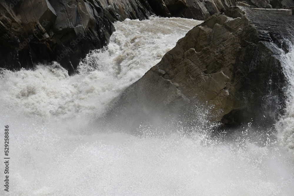 The mighty river crushing against the famous Tiger Leaping Gorge in Yunnan province of Western China - the water flow in the river forming the gorge is incredible in terms of volume and speed The mighty river crushing against the famous Tiger Leaping Gorge in Yunnan province of Western China - the water flow in the river forming the gorge is incredible in terms of volume and speed