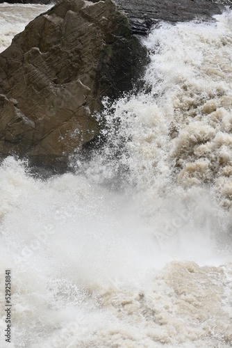 The mighty river crushing against the famous Tiger Leaping Gorge in Yunnan province of Western China - the water flow in the river forming the gorge is incredible in terms of volume and speed