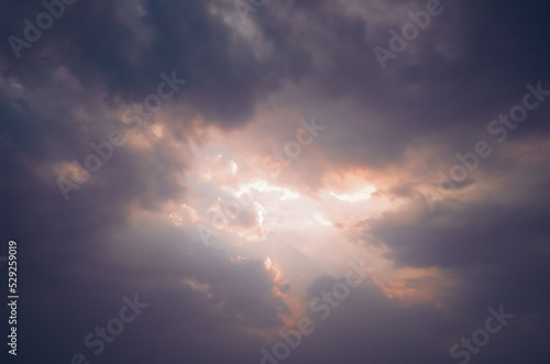 Dramatic weather conditions, thunderstorms clouds in sky, black cloud photography, nature background, sun rays shining 